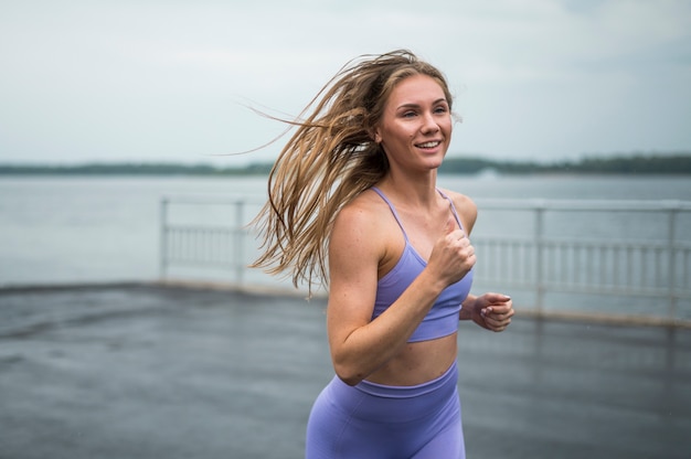 Young sexy woman running medium shot