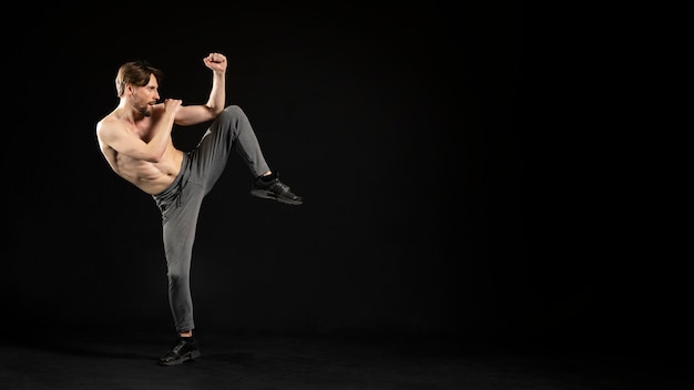 Free photo young shirtless athletic man doing fights