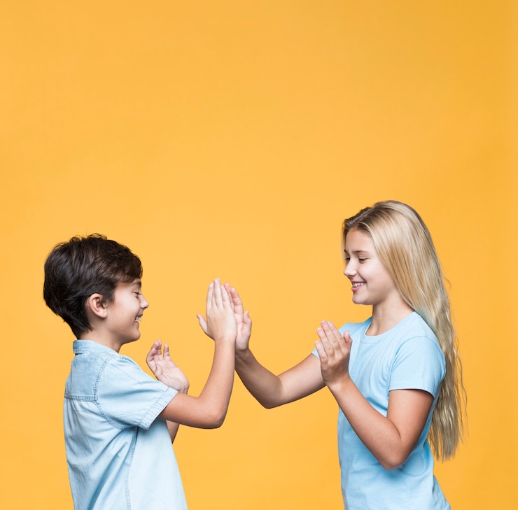 Free Photo young sibling playing with copy-space