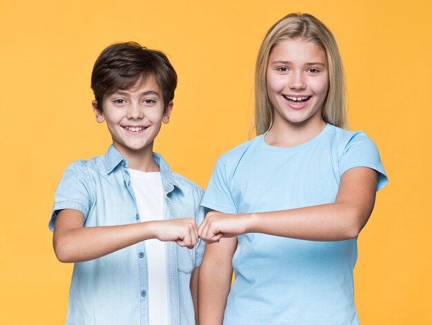 Young siblings fist salute