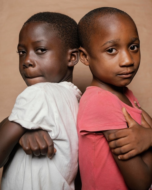 Free photo young siblings standing back to back