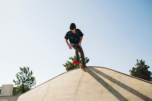 Young skater at the top of the half pipe