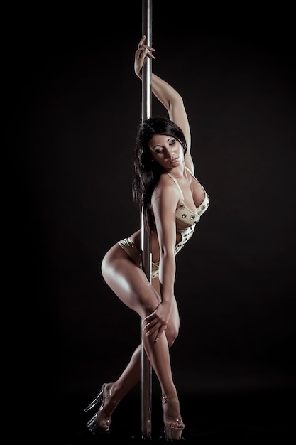 Free photo young slim pole dance woman on a black studio background