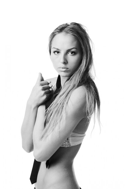 Young slim woman wearing bra on white background