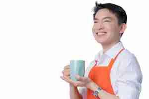 Free photo young smart attractive asian male restuarant owner hand sign ok gesture hand order online from home concept asian apron uniform smile warmw welcome for appllication order with free copyspace