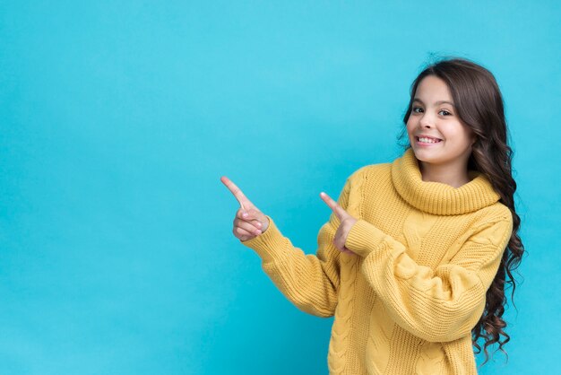 Young smiley girl portrait pointing