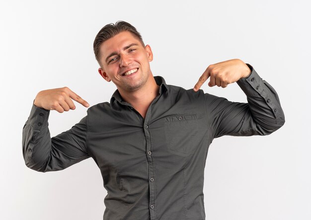 Young smiling blonde handsome man points at himself isolated on white space with copy space