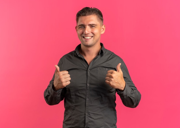 Free photo young smiling blonde handsome man thumbs up isolated on pink space with copy space