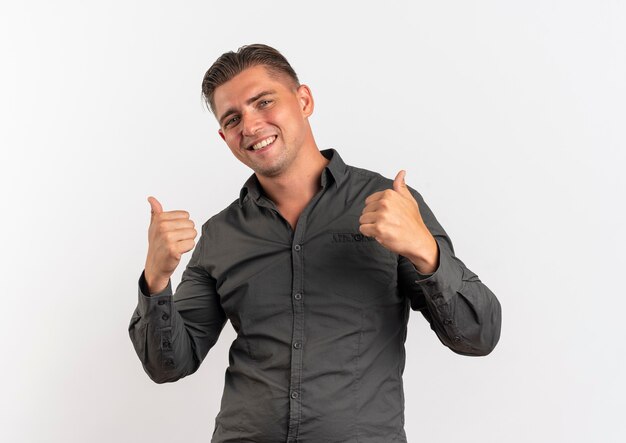 Young smiling blonde handsome man thumbs up looking at camera isolated on white background with copy space