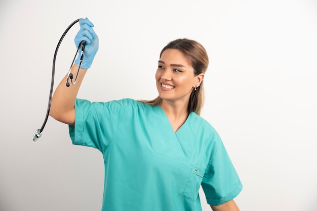 Young smiling female nurse posing with stethoscope.