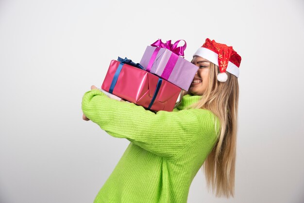 Young smiling woman holding in hands festive Christmas presents