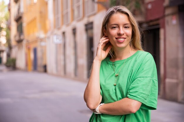 Young smiling woman look at camera in the city