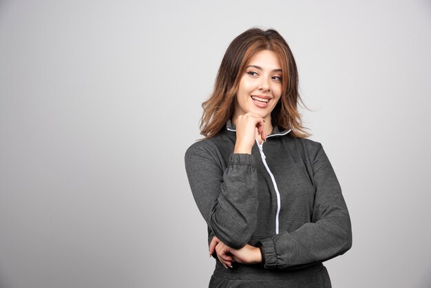 Young smiling woman standing and posing .