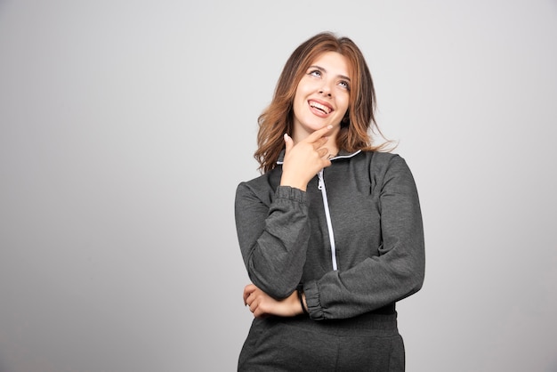 Young smiling woman standing and posing .