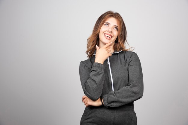 Young smiling woman standing and posing .