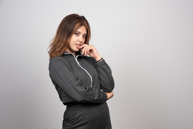 Young smiling woman standing and posing .