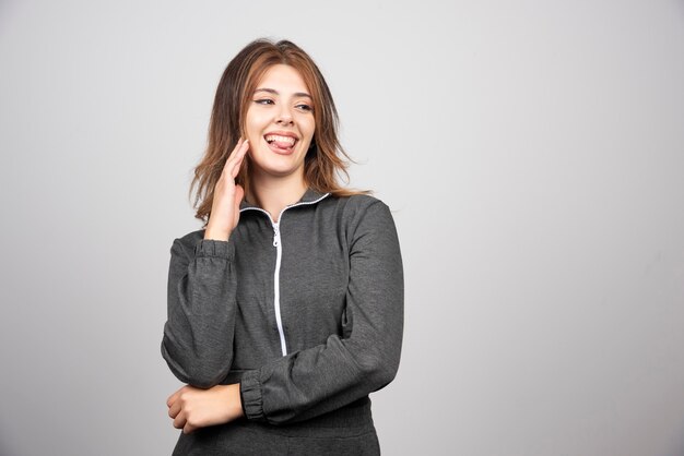 Young smiling woman standing and posing .