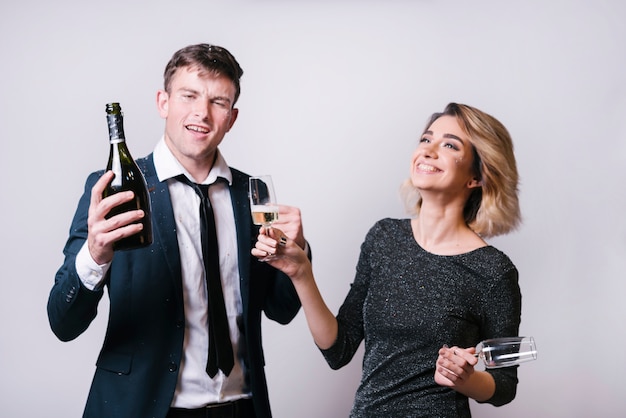 Young smiling woman with glasses near man with bottle of drink 