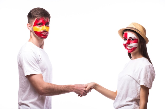 Young spanish and croatian football fan handshake isolated on white wall