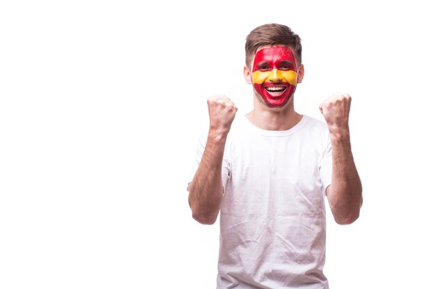 Young spanish man football fan with win gesture isolated on white wall