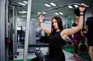 Free photo young sport girl workout in gym fitness woman doing exercises