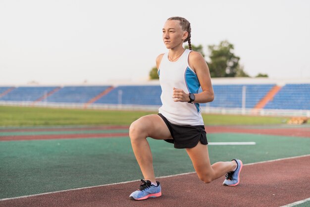 Young sportive woman warm up at stadium