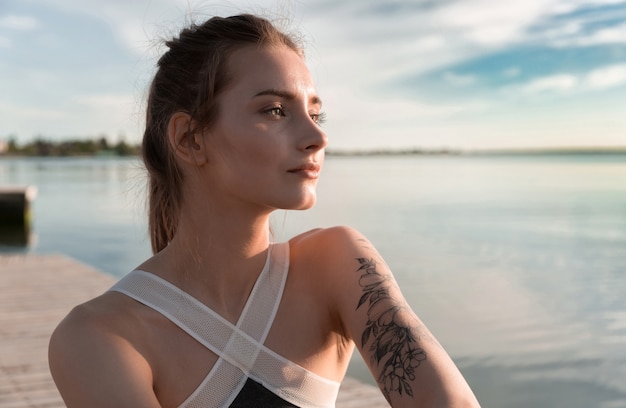 Young sports beautiful woman at the beach