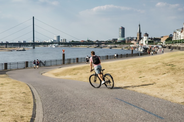 Young sports man on a bicycle in a European city. Sports in urban environments.