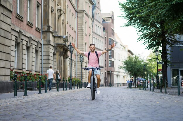 Young sports man on a bicycle in a European city. Sports in urban environments.