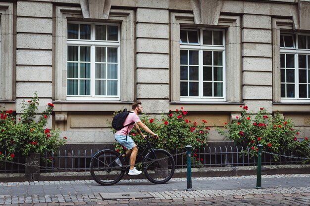 Young sports man on a bicycle in a European city. Sports in urban environments.