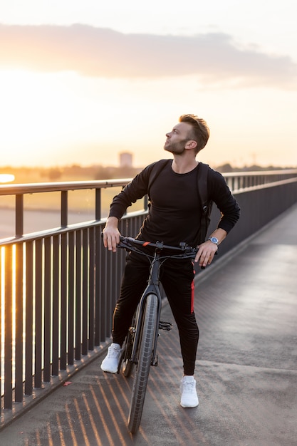 Young sports man on a bicycle in a European city. Sports in urban environments.