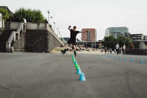 Young sports man on roller skates in a European city. Sports in urban environments.