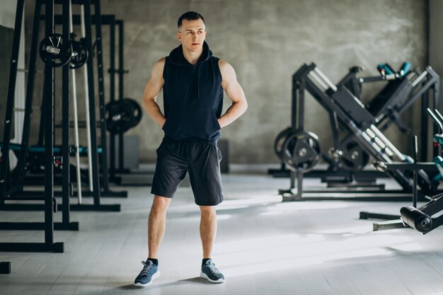 Young sports man training at the gym