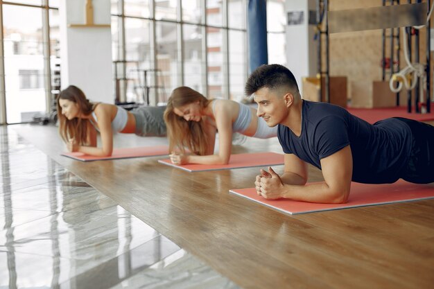 Young sports people training in a morning gym