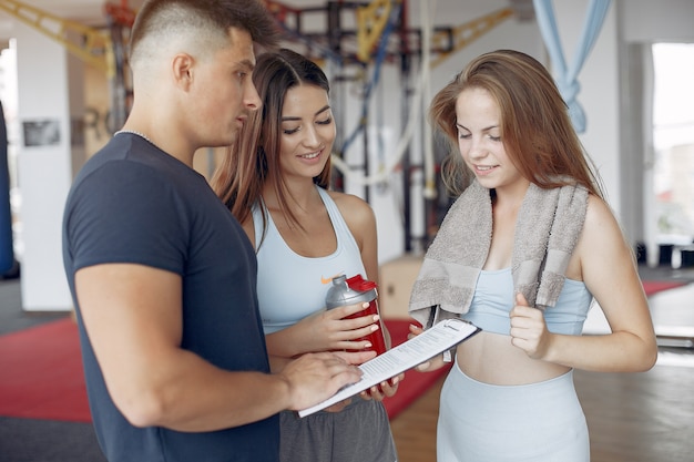 Free photo young sports people training in a morning gym