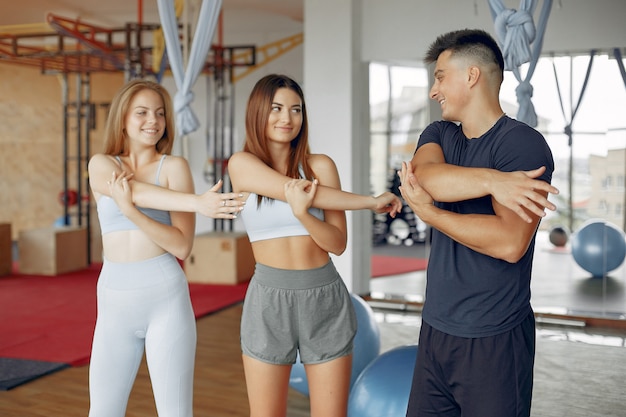 Free photo young sports people training in a morning gym