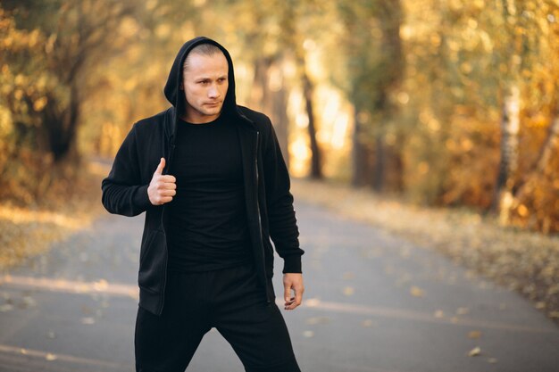 Young sportsman exercising in park