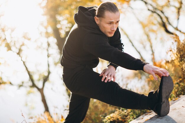 Young sportsman exercising in park