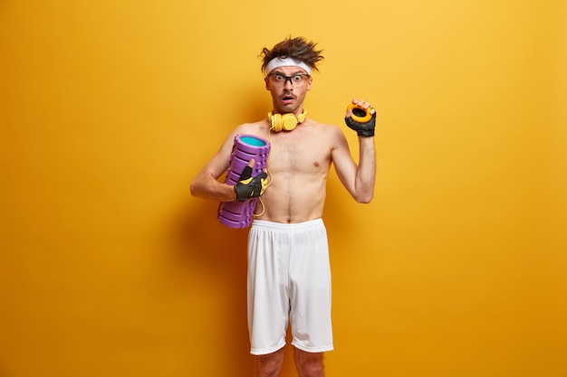 Young sportsman getting ready for his training isolated