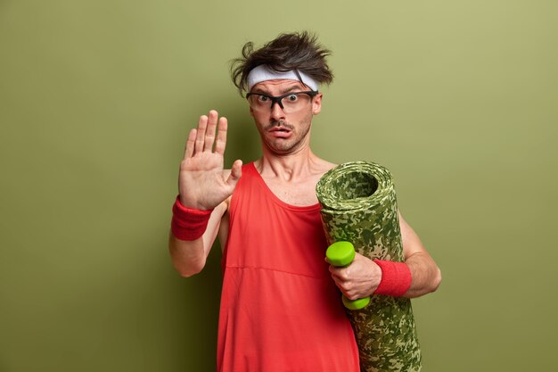 Young sportsman getting ready for his training isolated