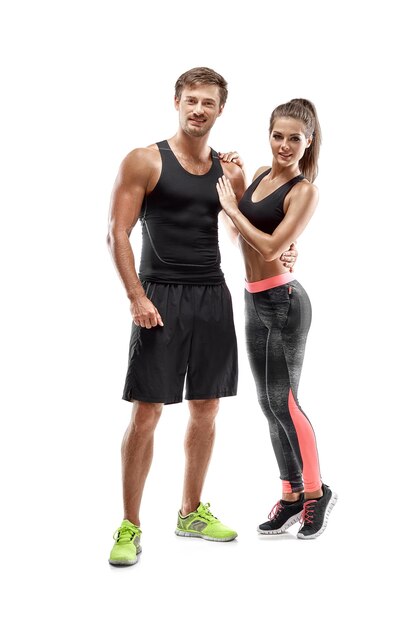 Young sportsmen couple woman and man in studio on white background. They look at the camera