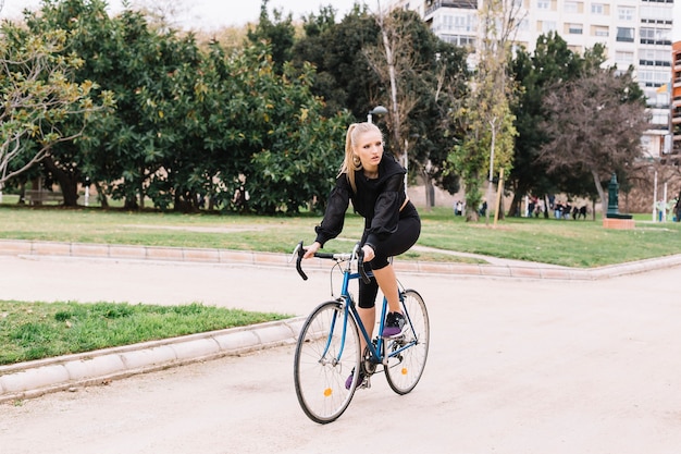 Young sportswoman on bicycle