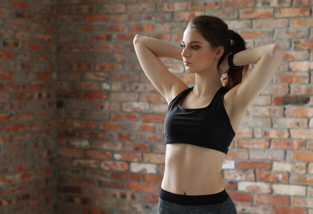 Young sportswoman stretching