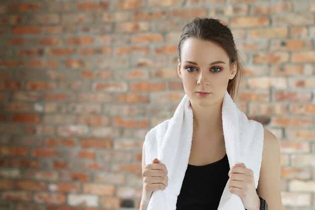 Young sportswoman with towel