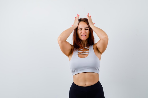 Young sporty woman in a gray top