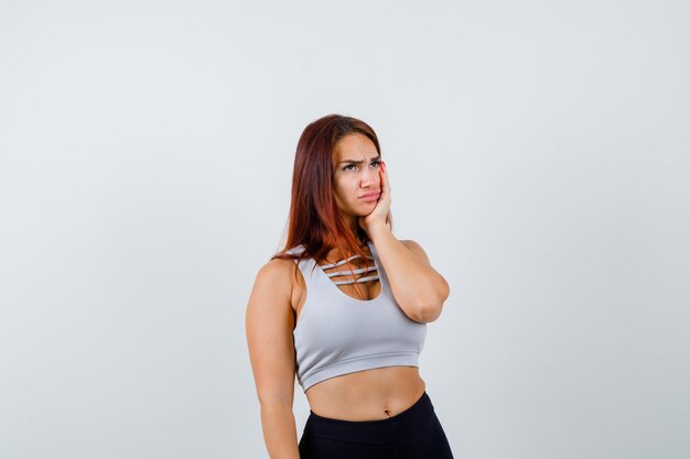 Young sporty woman in a gray top