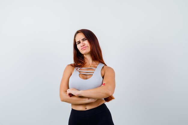 Young sporty woman in a gray top