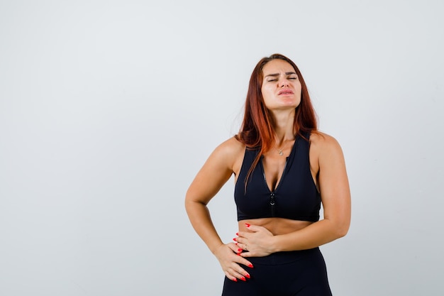 Young sporty woman having a stomachache