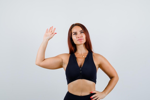 Young sporty woman with long hair in a black top