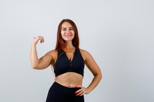 Young sporty woman with long hair in a black top